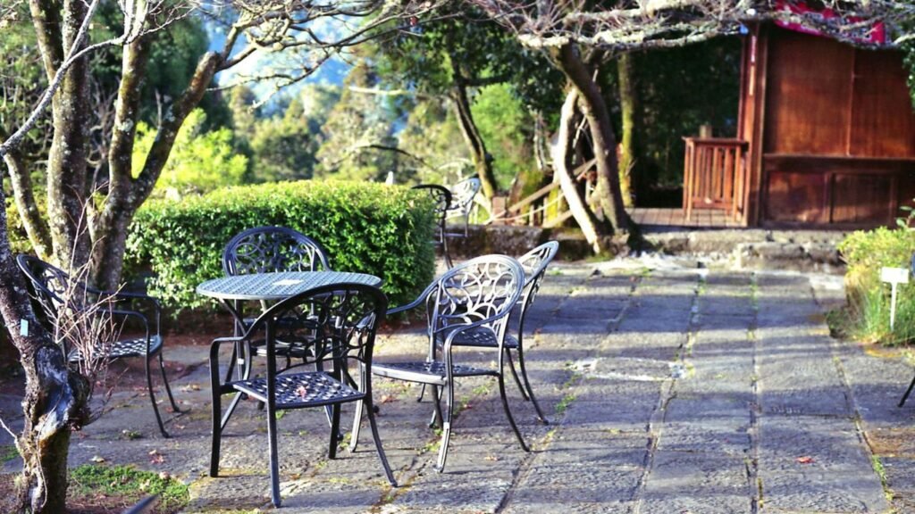 Antique wrought iron patio furniture with intricate detailing and patina