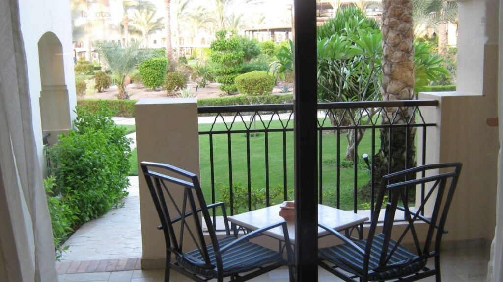 Traditional wrought iron patio furniture with intricate scrolls and curves